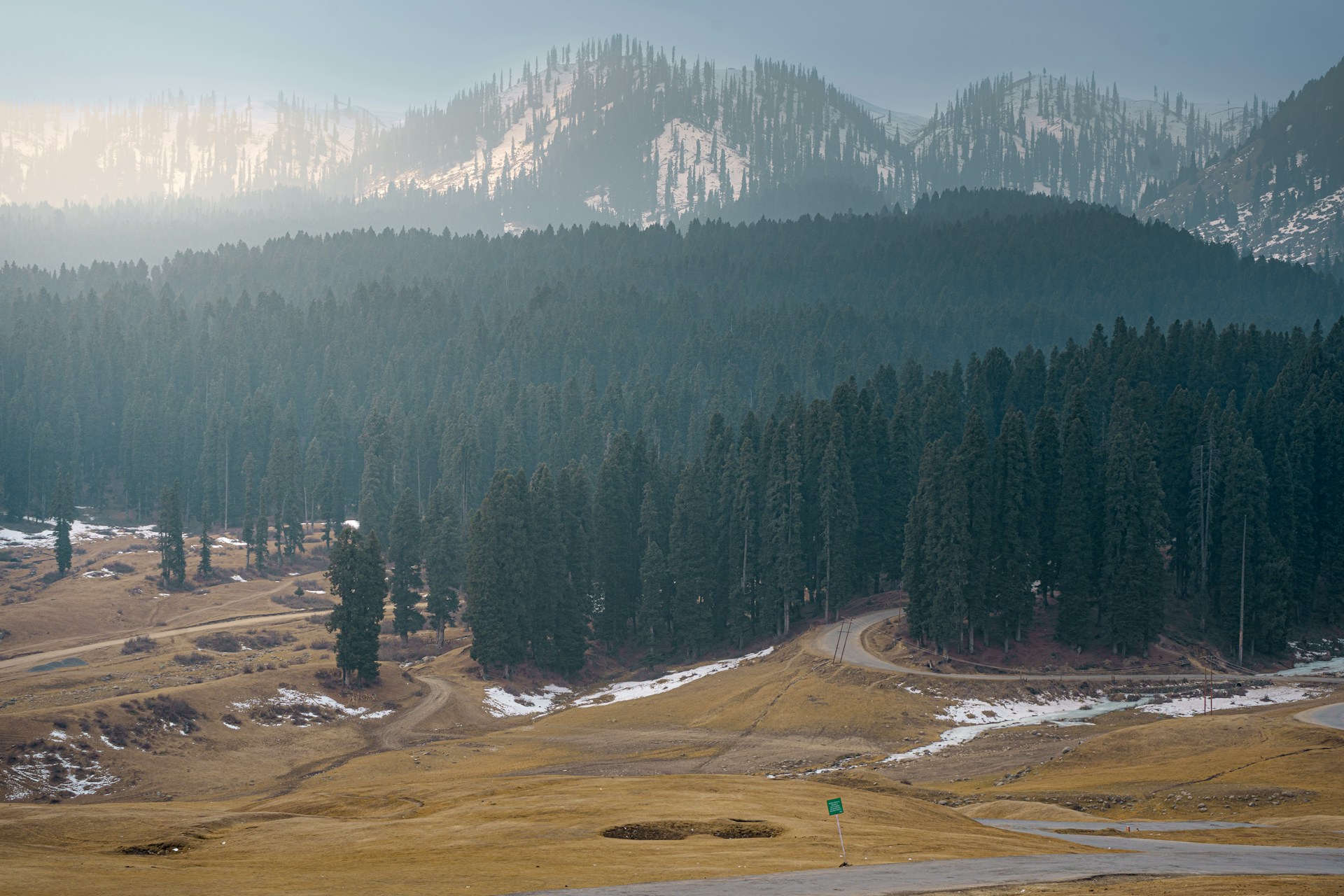 Wide green meadows and a shallow stream at Doodhpathri valley near Budgam in Kashmir