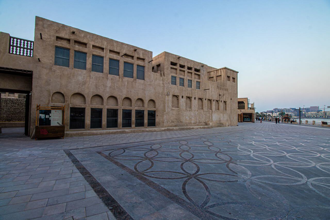 Wind-tower houses and abra boats along Dubai Creek in the Al Fahidi historical district