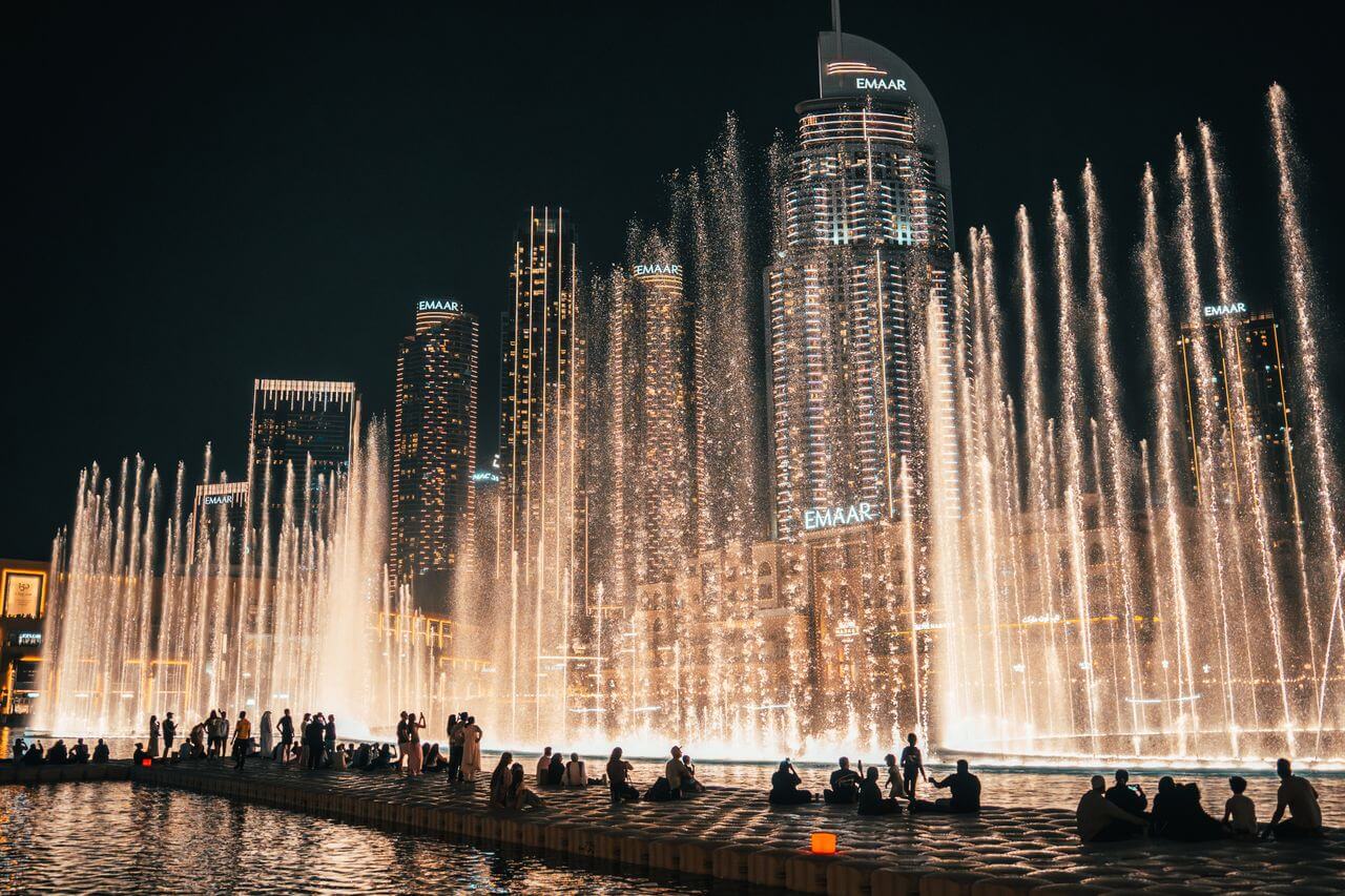 The Dubai Fountain performing in front of the Burj Khalifa at night