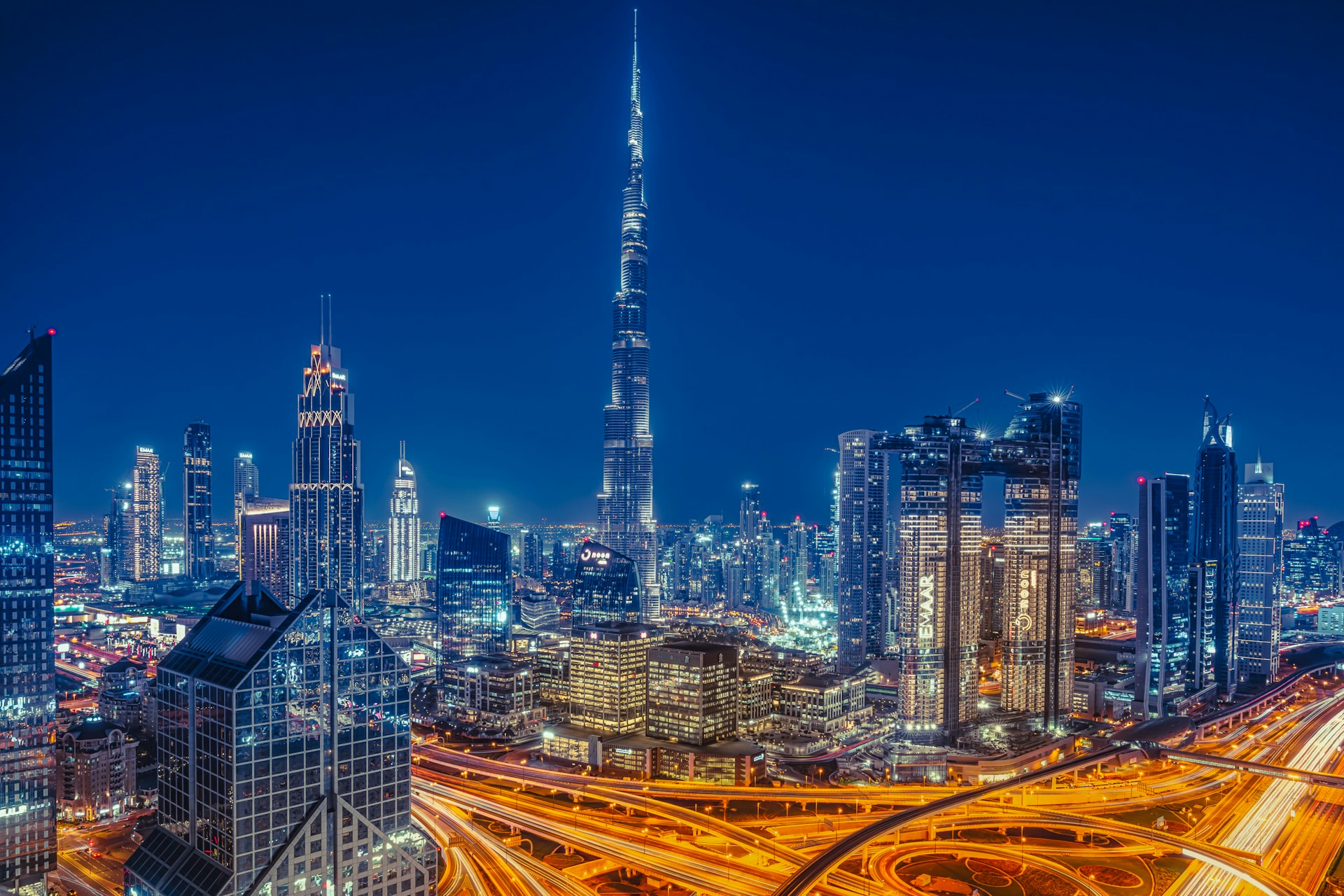 Dubai skyline at dusk with the Burj Khalifa towering over Downtown and Sheikh Zayed Road