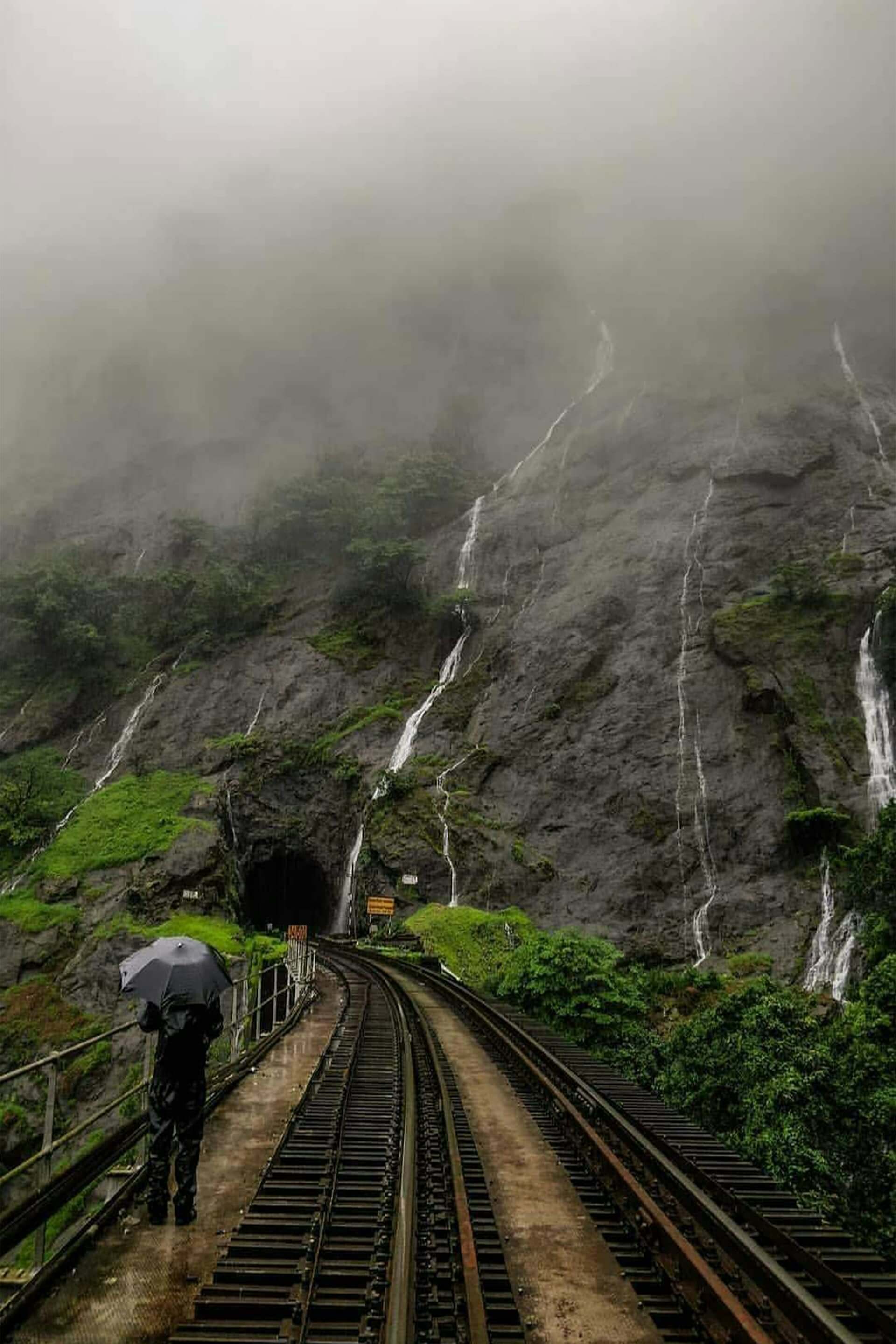 Dudhsagar Falls Goa Karnataka border four-tier waterfall railway bridge monsoon