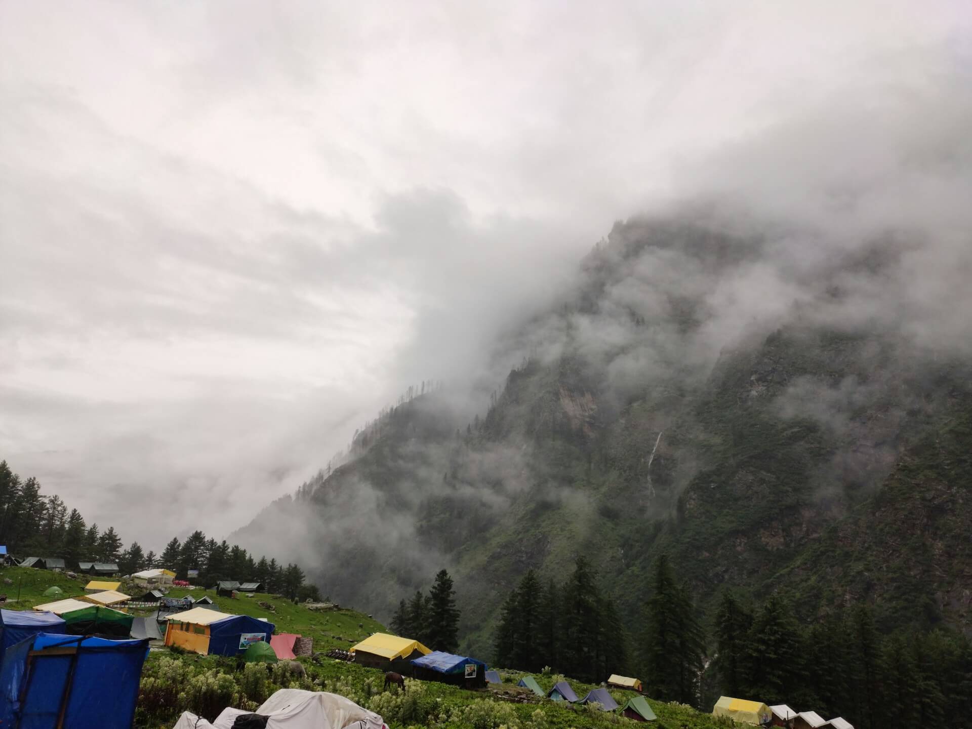 Kheerganga hot spring natural pool meadow Himalayan peaks Parvati Valley trek