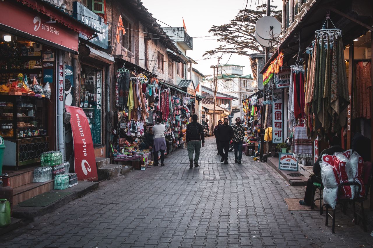 McLeod Ganj main street Dharamshala Tibetan flags cafes monks market