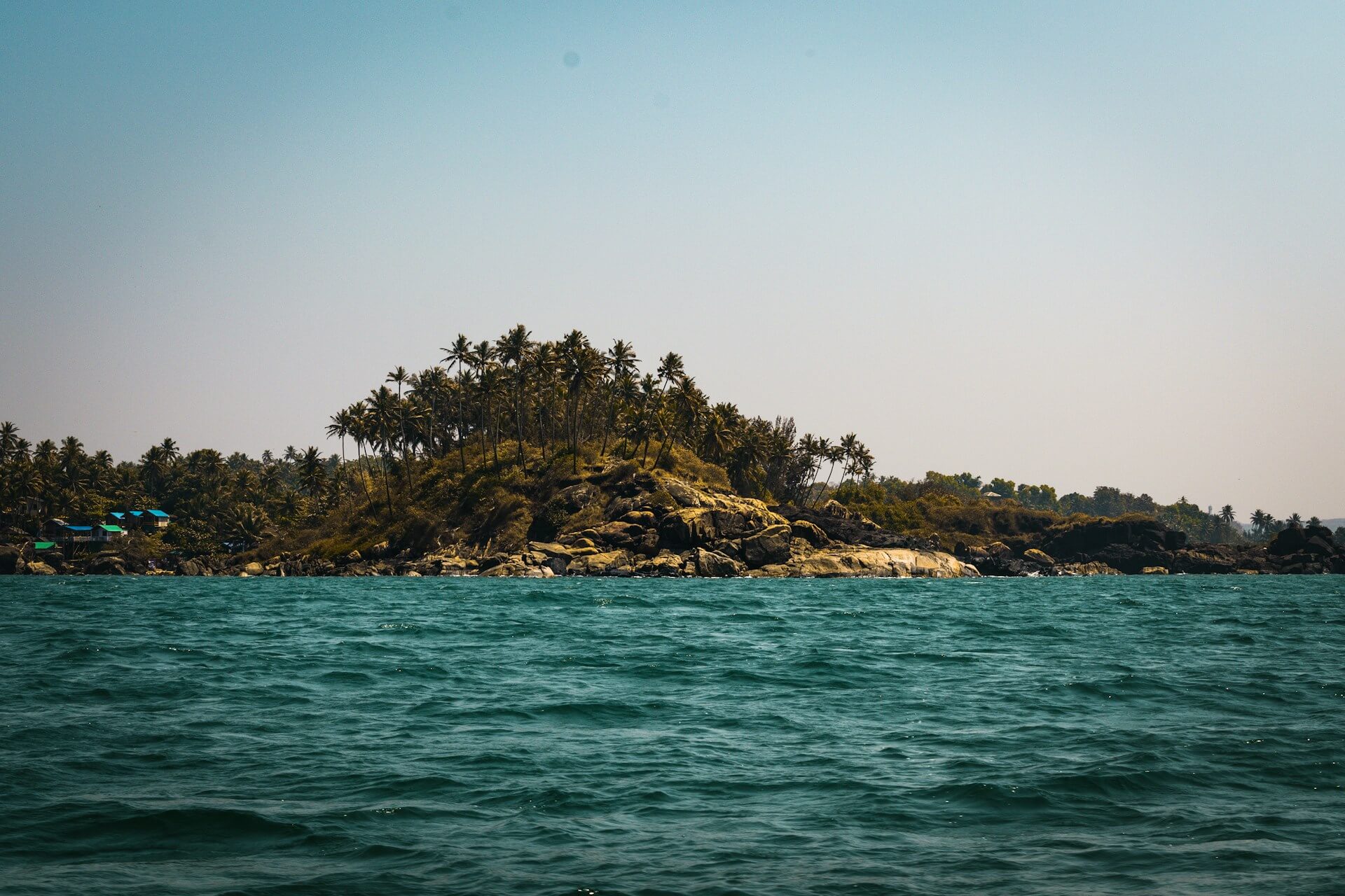 Palolem Beach South Goa crescent beach huts palm trees sunset