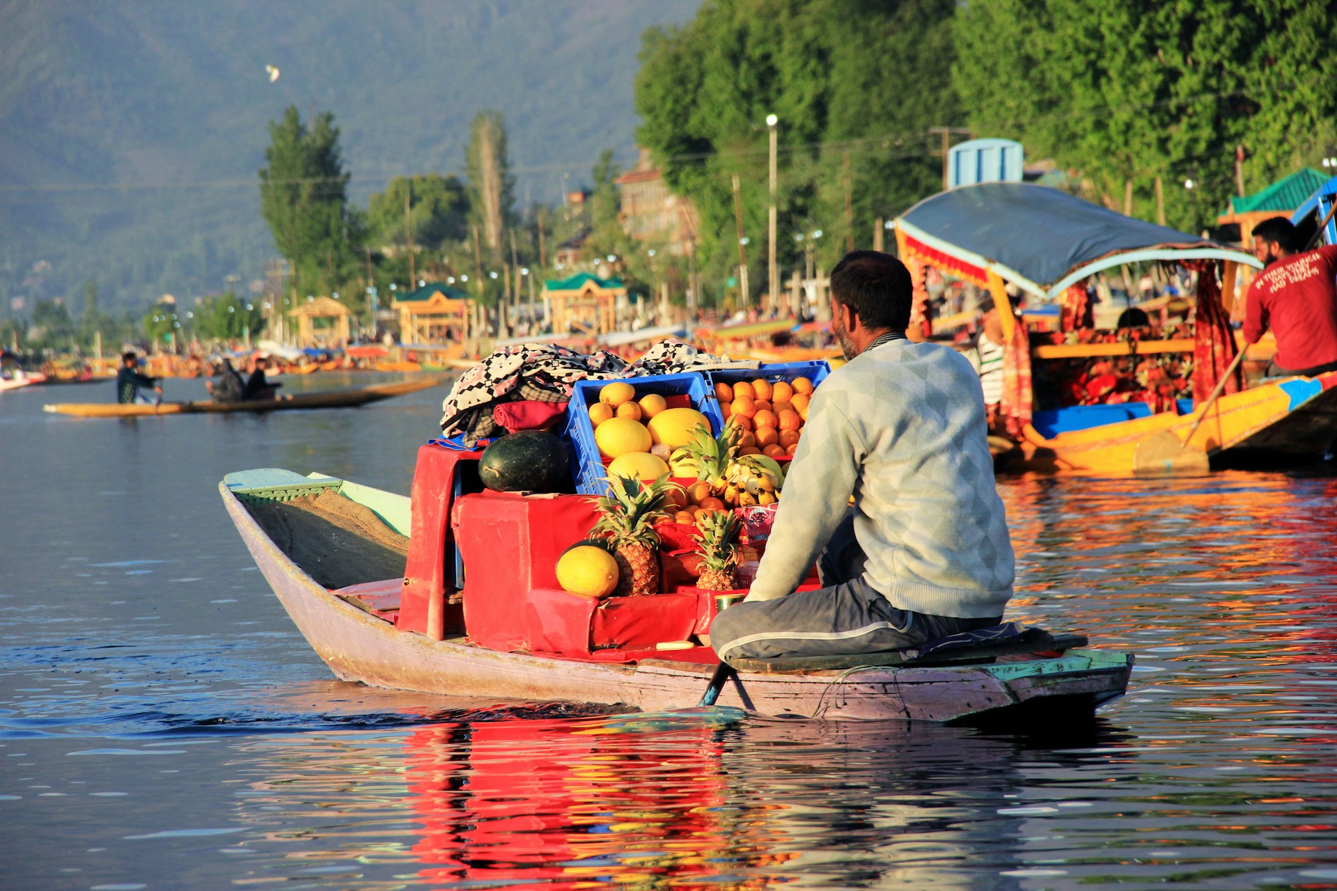 Vendors trading vegetables from shikaras at the floating market on Dal Lake at sunrise